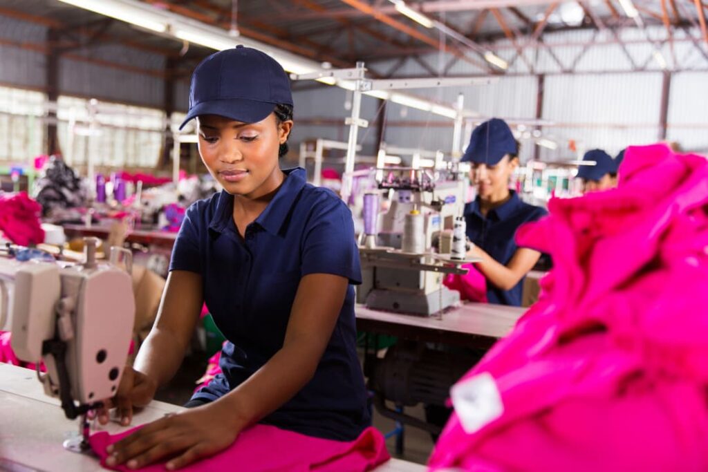 Garment factory workers operating textile machines